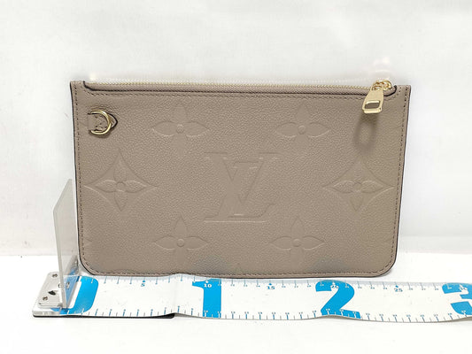 LOUIS VUITTON RFID verification impossible. Serial number verification impossible. Monogram Empreinte Louis Vuitton Neverfull Pouch in Taupe with Gold Hardware.