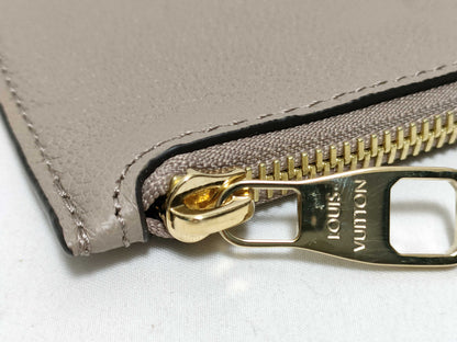 LOUIS VUITTON RFID verification impossible. Serial number verification impossible. Monogram Empreinte Louis Vuitton Neverfull Pouch in Taupe with Gold Hardware.