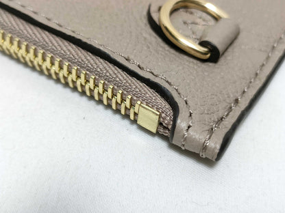LOUIS VUITTON RFID verification impossible. Serial number verification impossible. Monogram Empreinte Louis Vuitton Neverfull Pouch in Taupe with Gold Hardware.