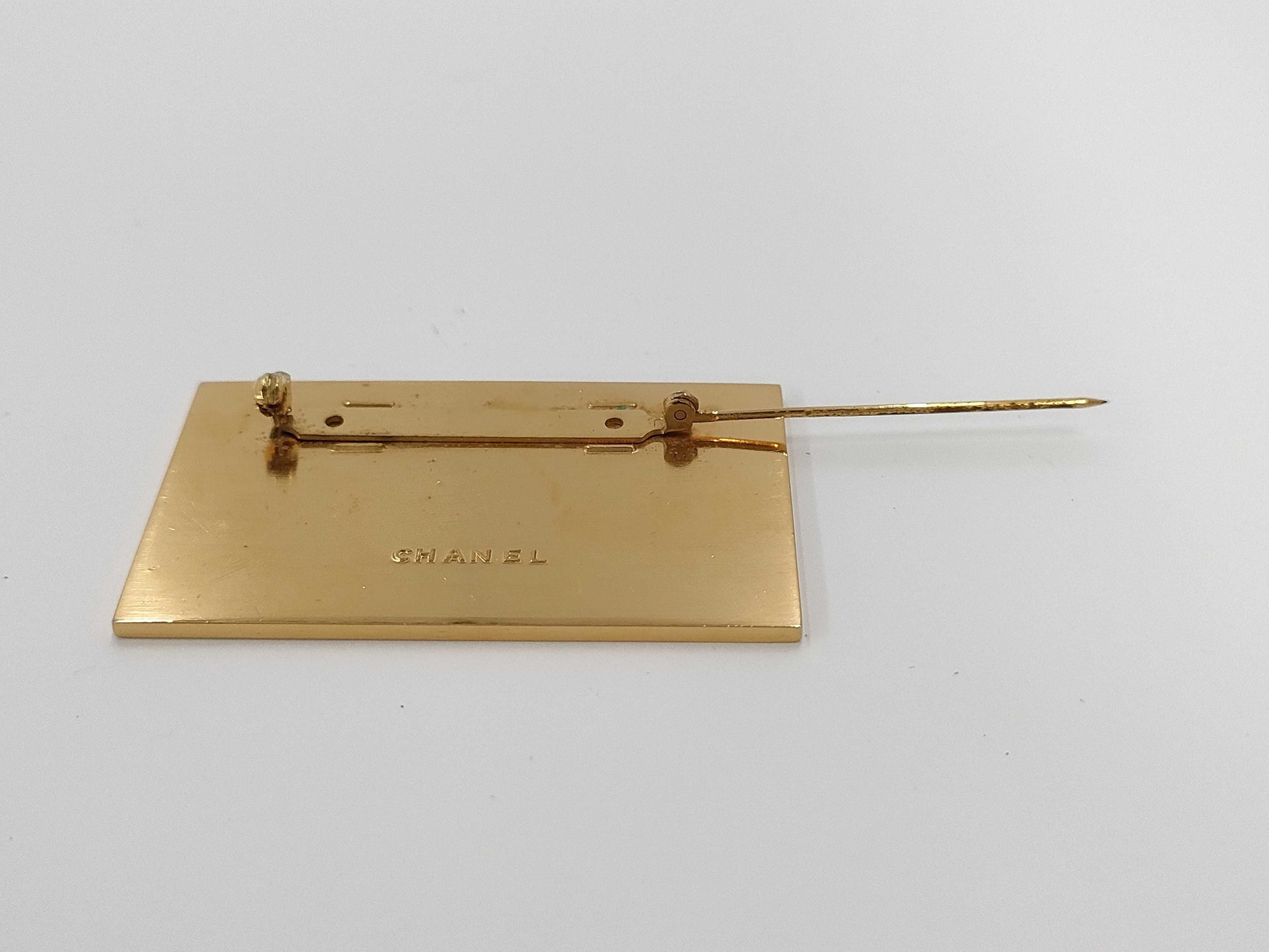 CHANEL logo plate gold brooch