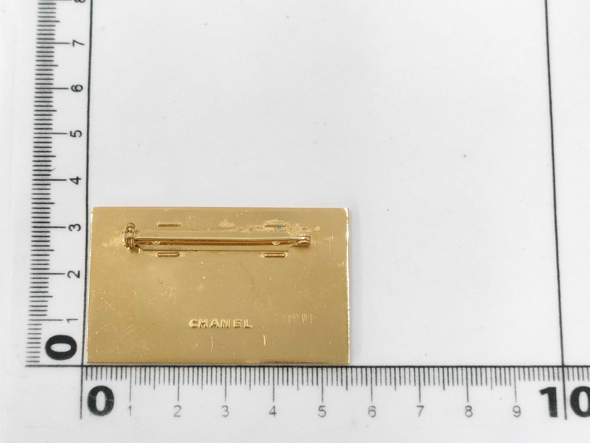 CHANEL logo plate gold brooch