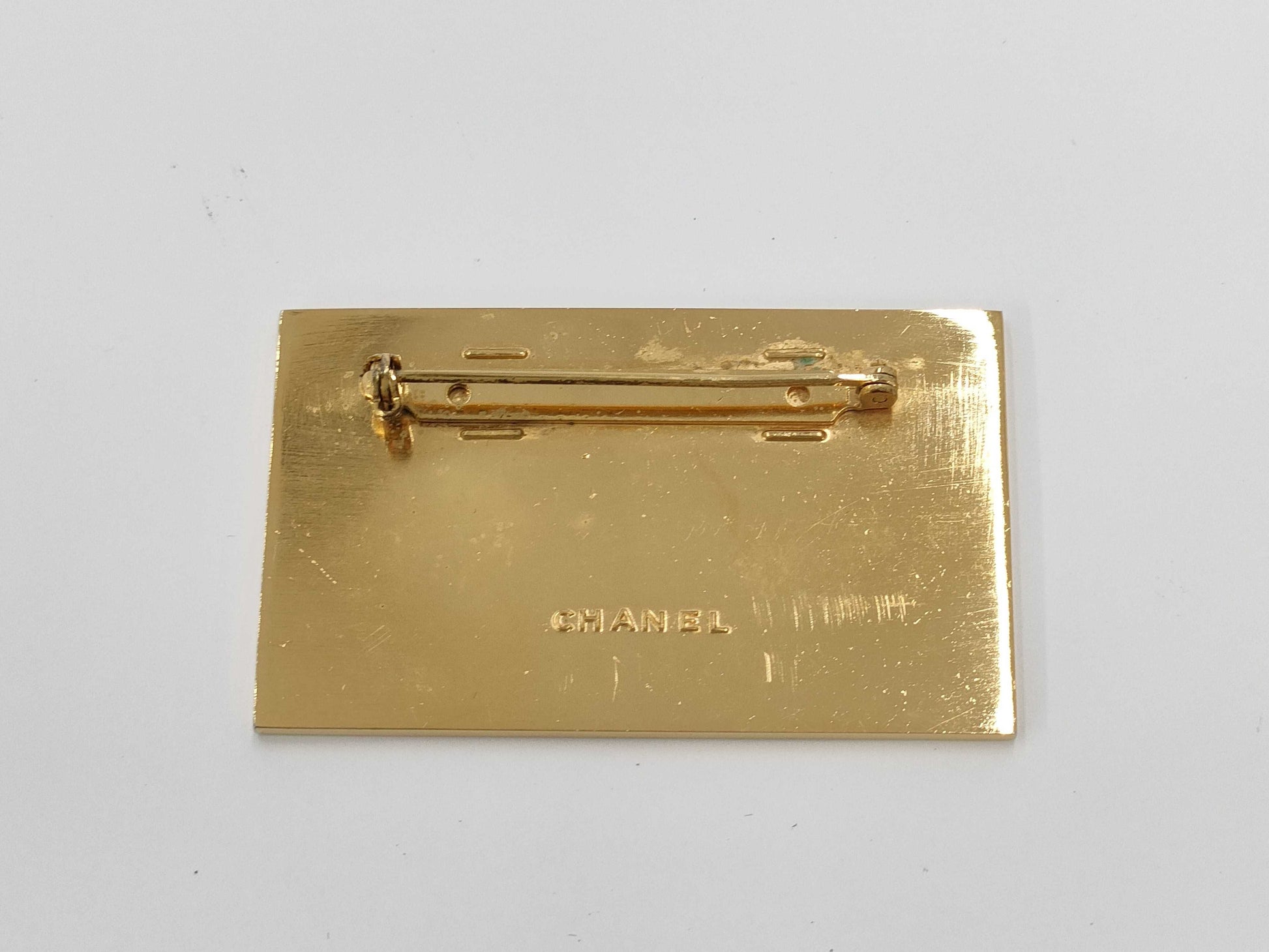 CHANEL logo plate gold brooch