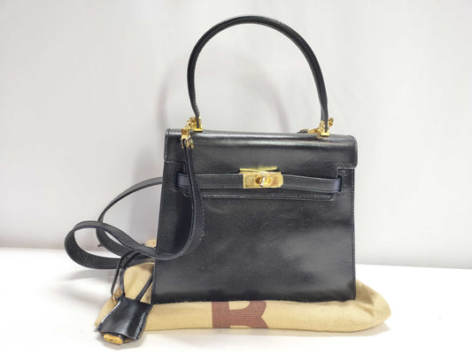 BALLY 2-way Kelly-style shoulder bag with top handle and turnlock. Black leather.