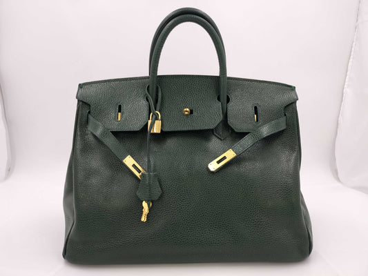 Green handbag with padlock, key and clochette