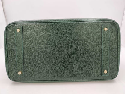 Green handbag with padlock, key and clochette