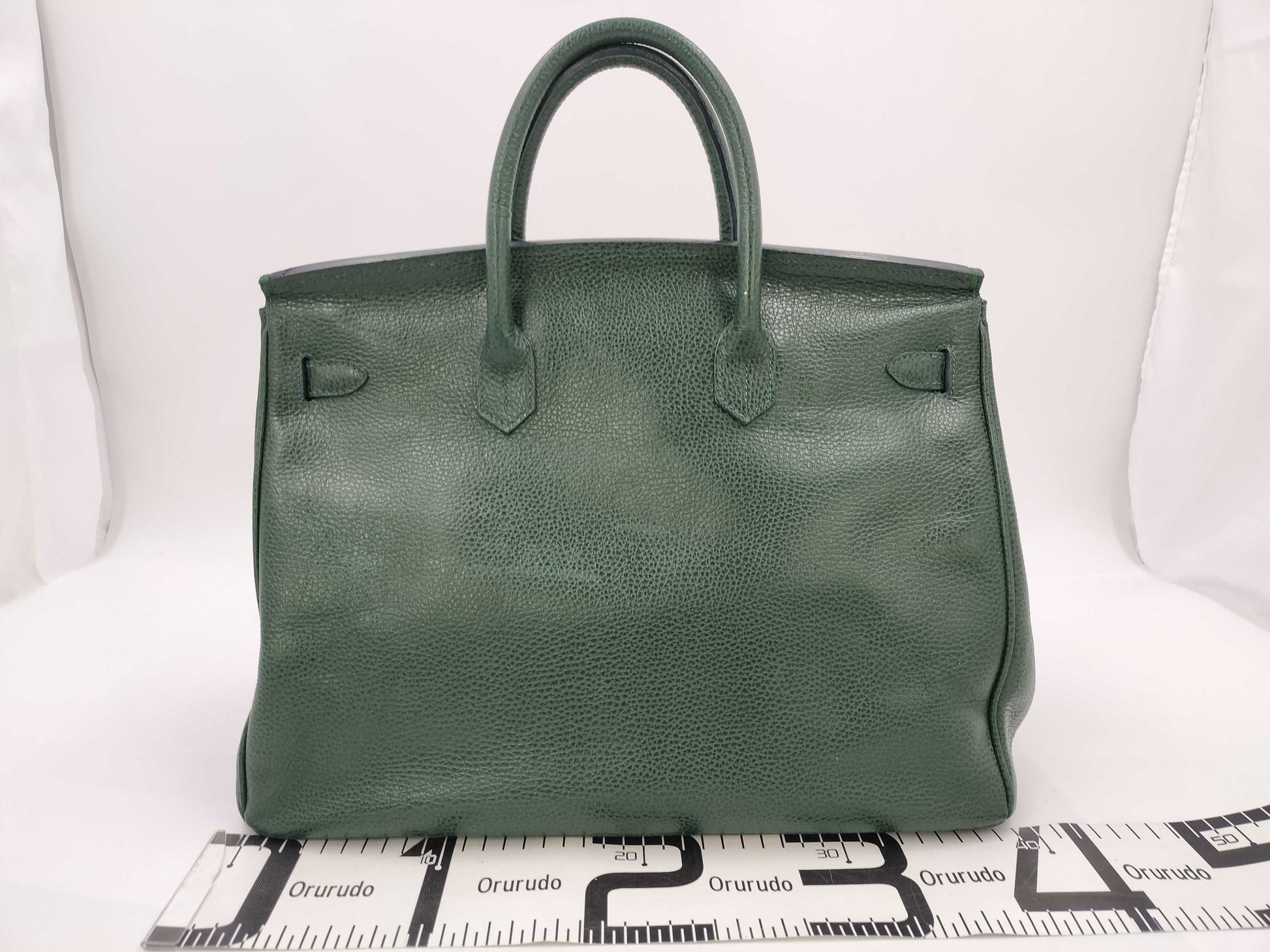 Green handbag with padlock, key and clochette