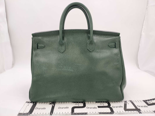 Green handbag with padlock, key and clochette