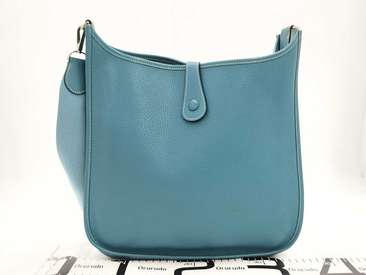 HERMES Evelyn GM Shoulder Bag in Taurillon/Blue Jean with Palladium Hardware and Dust Bag