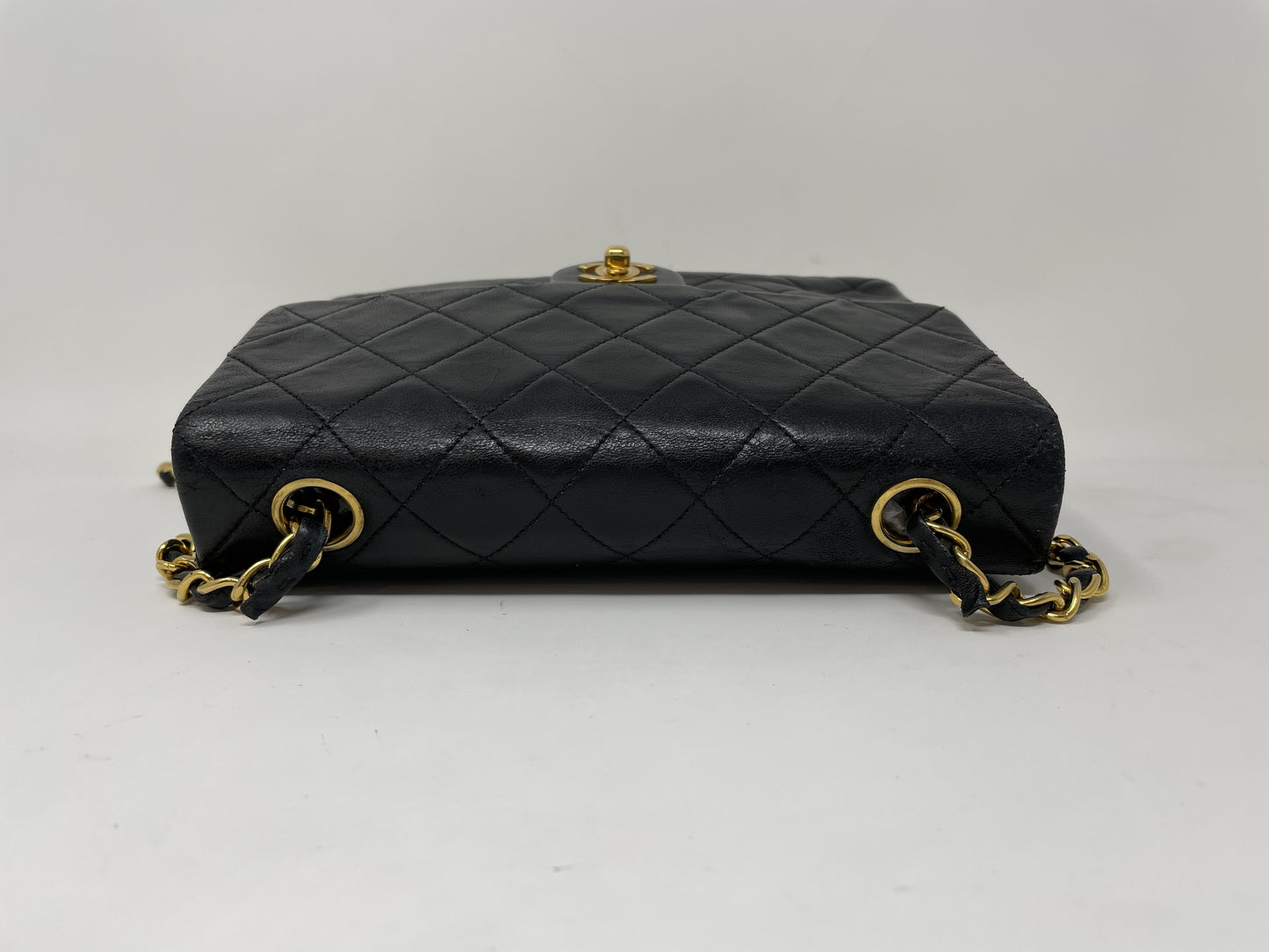 CHANEL CHANEL Mini Matelasse Shoulder Bag with Gold Hardware, Lambskin Coco Mark, and Turn Lock.