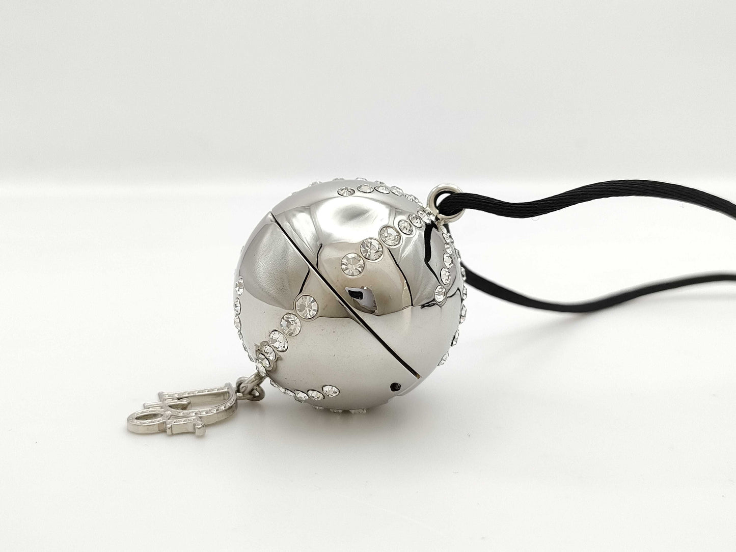 Dior logo mirror ball necklace with rhinestones and lip gloss.