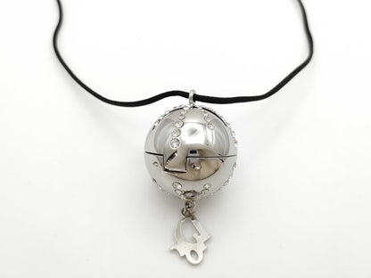 Dior logo mirror ball necklace with rhinestones and lip gloss.