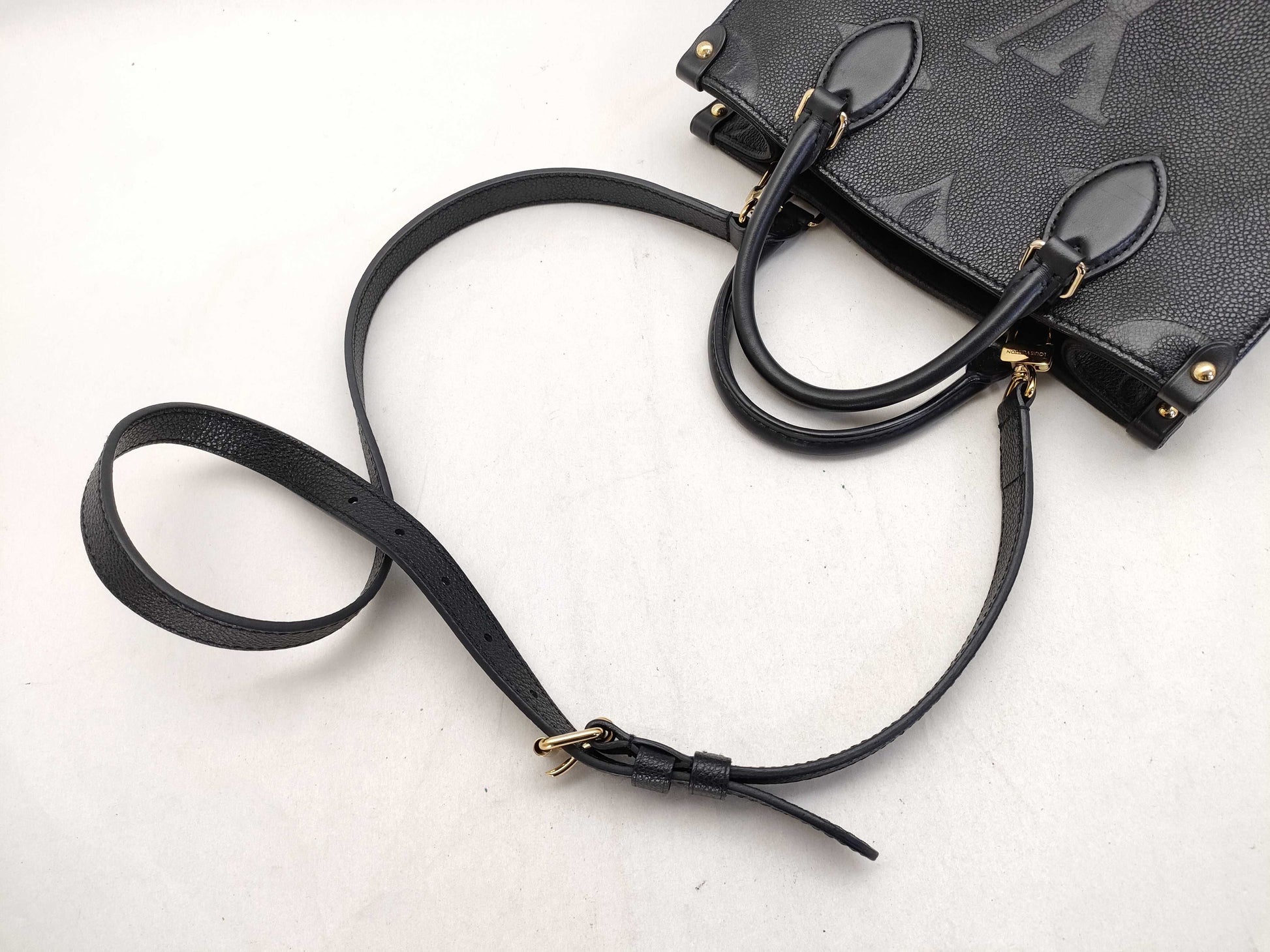 LOUIS VUITTON Monogram Empreinte Louis Vuitton On the Go PM Empreinte Handbag