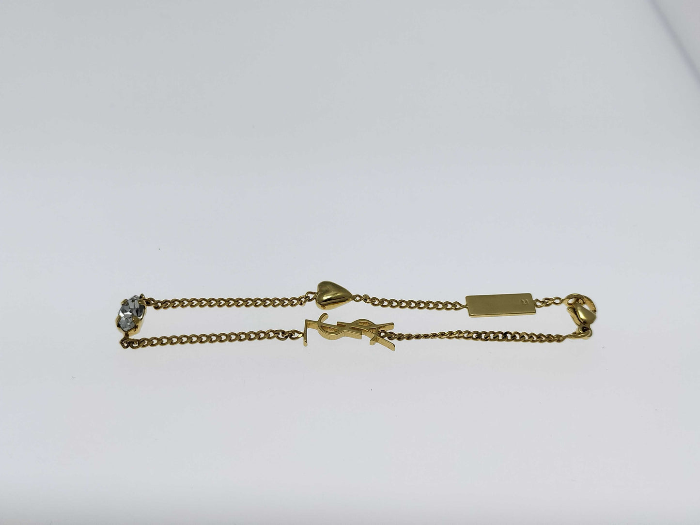 Yves Saint Laurent YSL Logo Cassandra Heart Charm Bracelet in Gold with Rhinestones. Includes Box and Dust Bag.