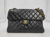 CHANEL Chain Shoulder Bag in Black and Gold