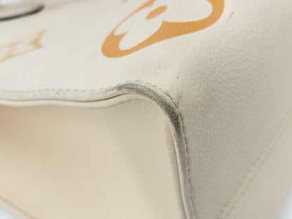 LOUIS VUITTON M45717 Monogram Empreinte On the Go MM Crème Saffron RFID Verified Tote Bag