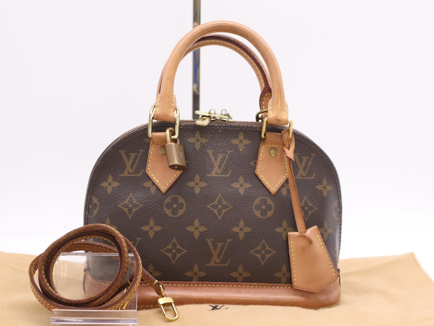 LOUIS VUITTON M53152 Monogram Alma BB Handbag with Shoulder Strap, Padlock, Two Keys, Cloche, and Dust Bag
