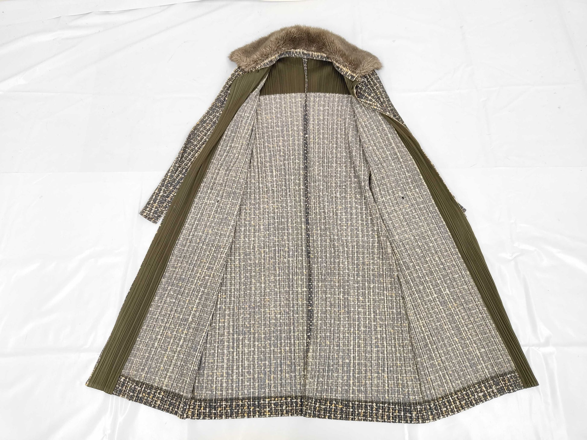 PLEATS PLEASE Issey Miyake long coat with fur collar and shoulder pads, all-over print