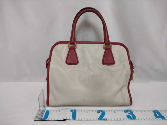 PRADA BN2578 Bicolor Saffiano Leather Handbag in Red and White, with Shinjuku Isetan Warranty, Cloche, and White Tag.