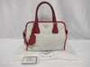 PRADA BN2578 Bicolor Saffiano Leather Handbag in Red and White, with Shinjuku Isetan Warranty, Cloche, and White Tag.