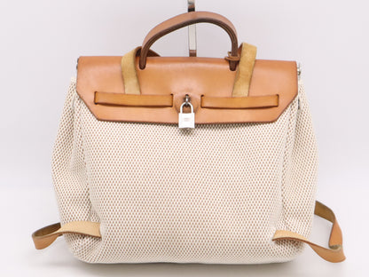 HERMES Toile GM x Leather Air Bag Ad PM Backpack in Brown, Beige, and Natural. Includes a padlock, two keys, a dust bag, and a box. H stamped. 2004.