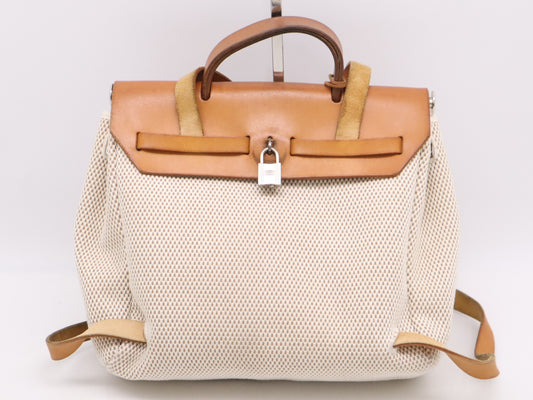 HERMES Toile GM x Leather Air Bag Ad PM Backpack in Brown, Beige, and Natural. Includes a padlock, two keys, a dust bag, and a box. H stamped. 2004.