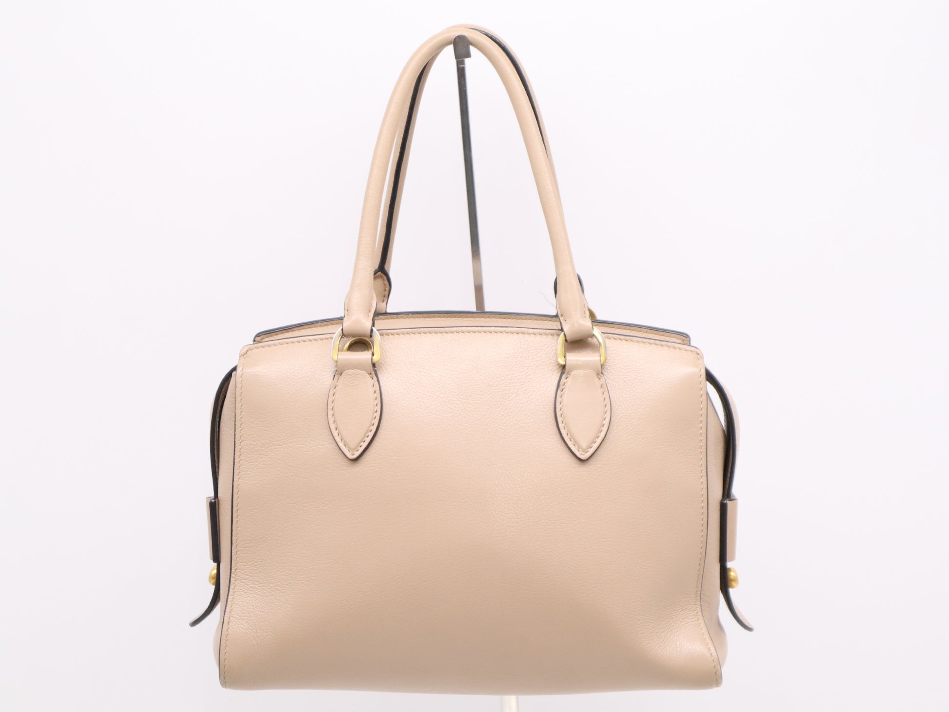 PRADA 2-way leather handbag in beige with GD hardware, shoulder strap, and clochette.