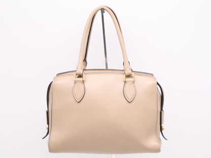 PRADA 2-way leather handbag in beige with GD hardware, shoulder strap, and clochette.