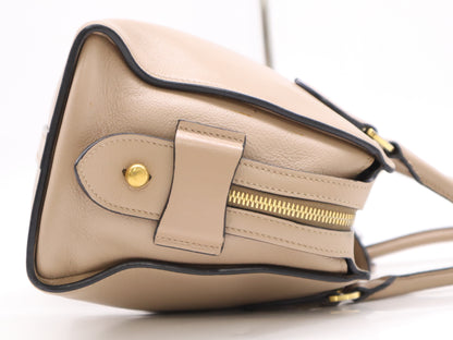 PRADA 2-way leather handbag in beige with GD hardware, shoulder strap, and clochette.