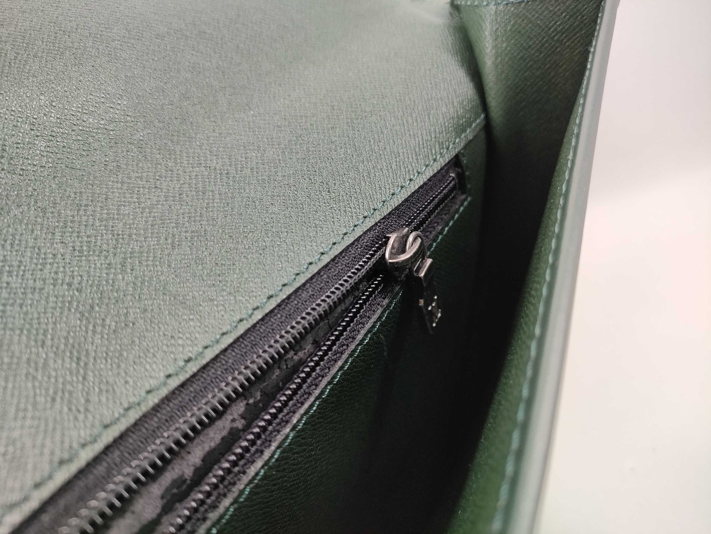 LOUIS VUITTON Taiga flap-style second bag with some deterioration inside the pocket.