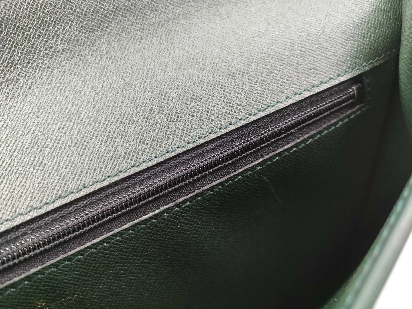 LOUIS VUITTON Taiga flap-style second bag with some deterioration inside the pocket.