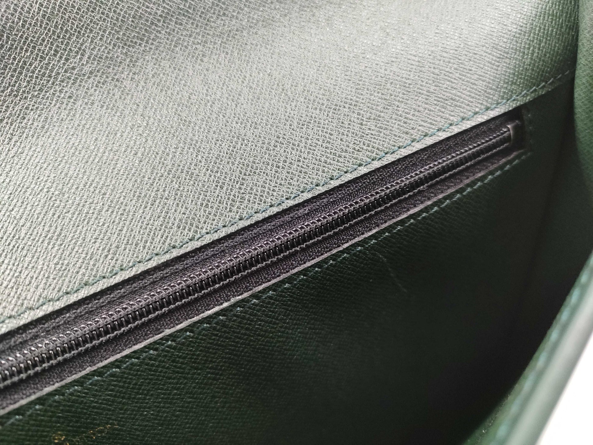 LOUIS VUITTON Taiga flap-style second bag with some deterioration inside the pocket.