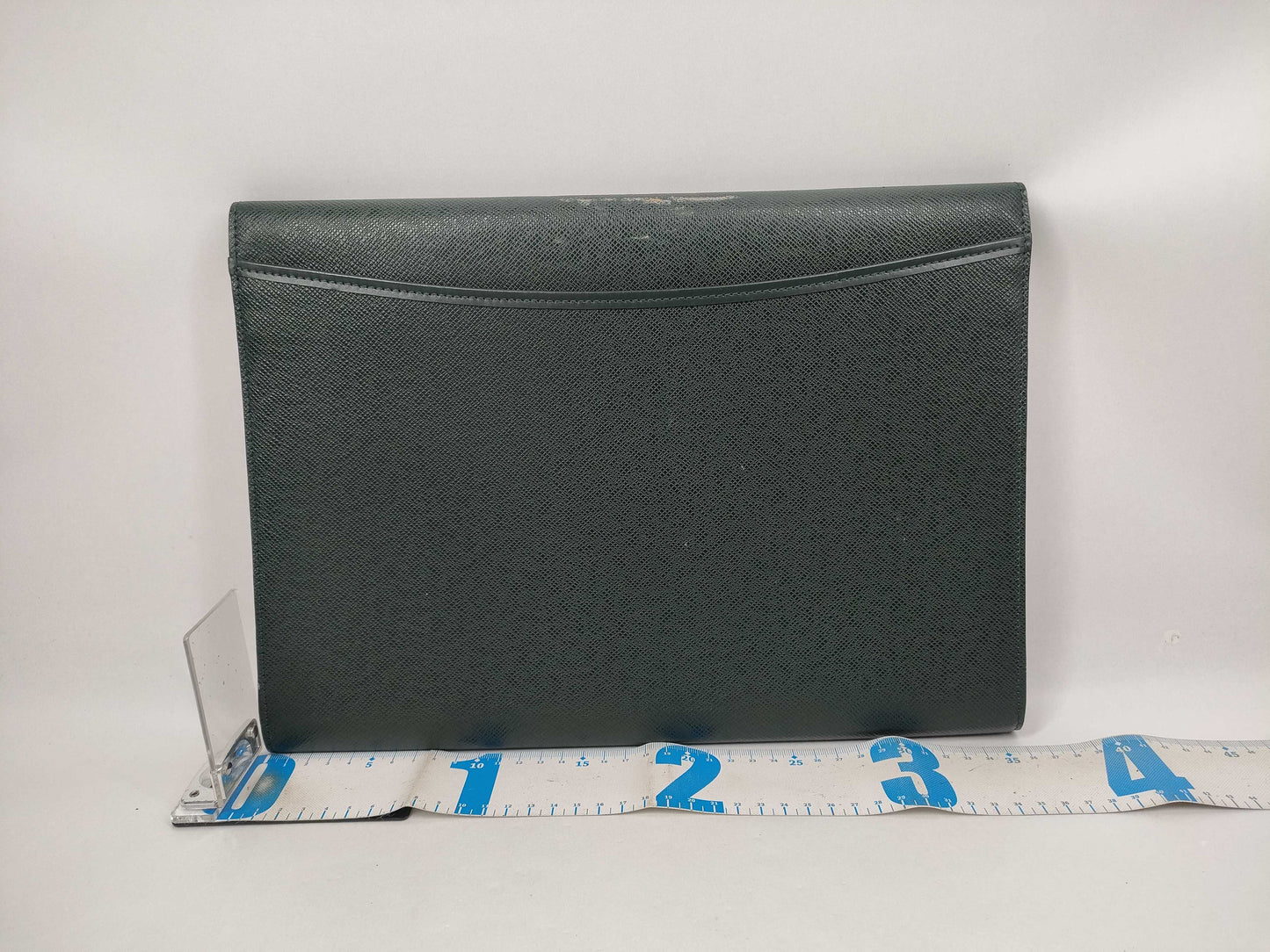 LOUIS VUITTON Taiga flap-style second bag with some deterioration inside the pocket.