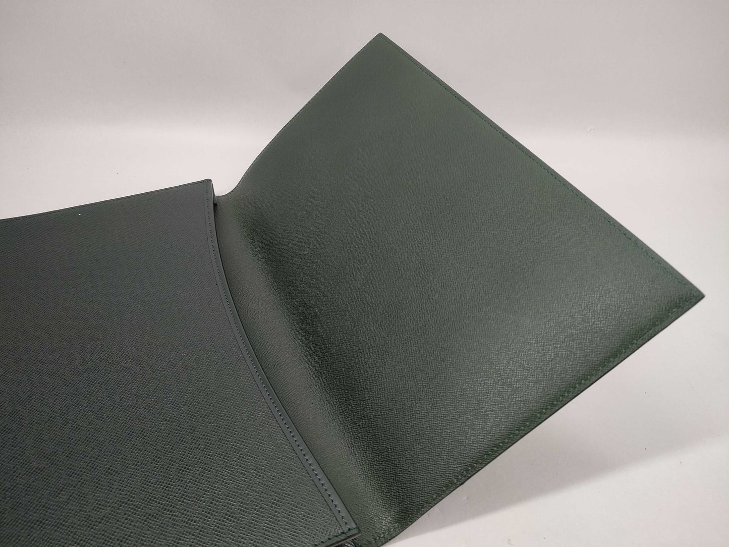 LOUIS VUITTON Taiga flap-style second bag with some deterioration inside the pocket.