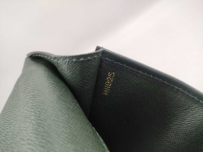 LOUIS VUITTON Taiga flap-style second bag with some deterioration inside the pocket.