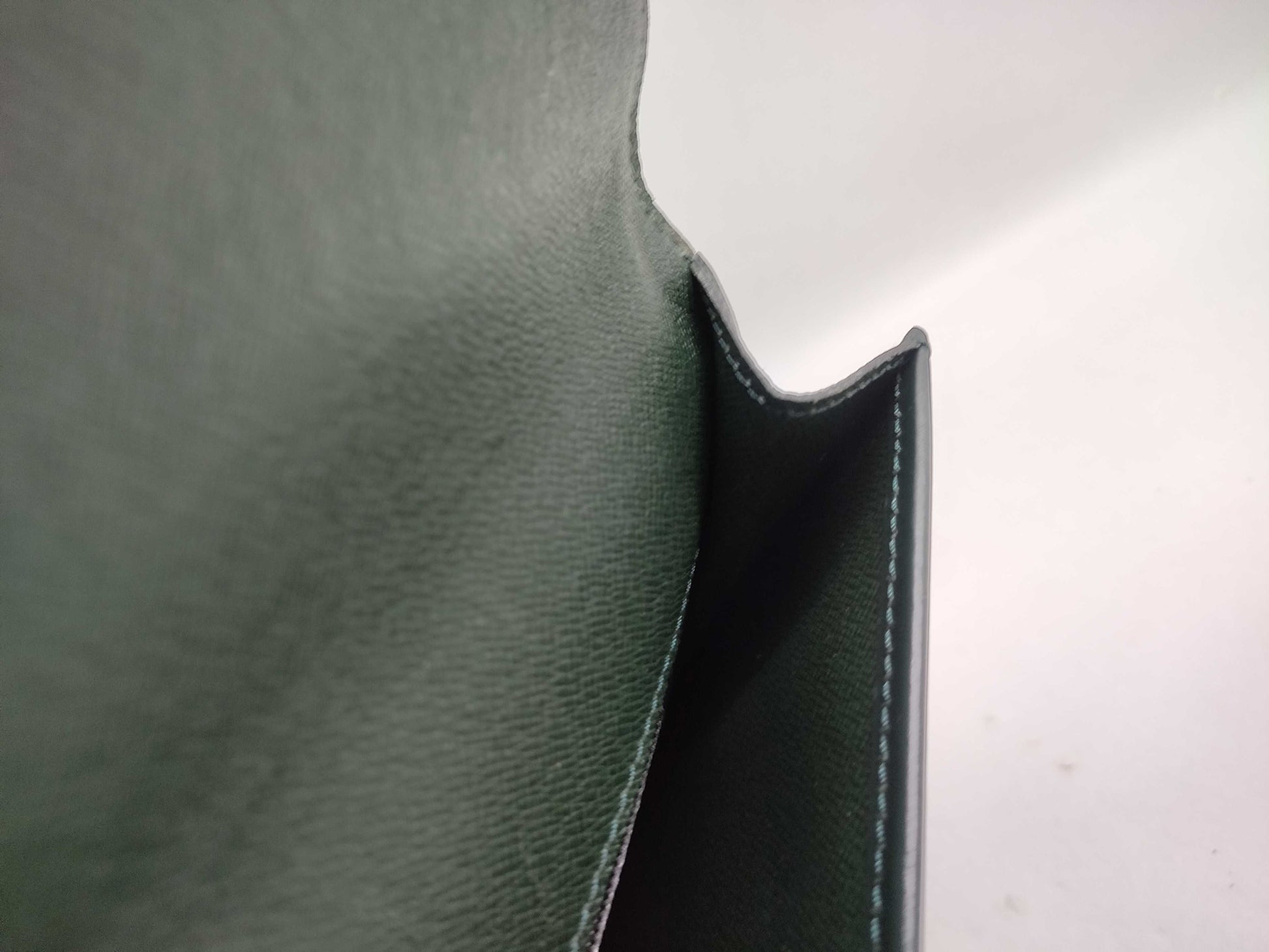 LOUIS VUITTON Taiga flap-style second bag with some deterioration inside the pocket.