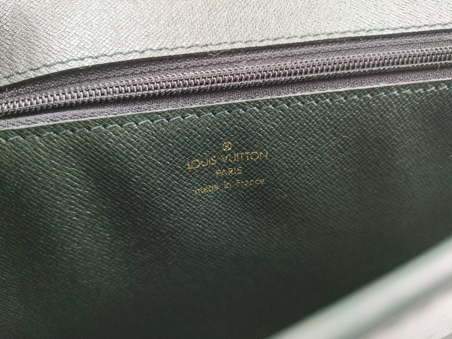 LOUIS VUITTON Taiga flap-style second bag with some deterioration inside the pocket.