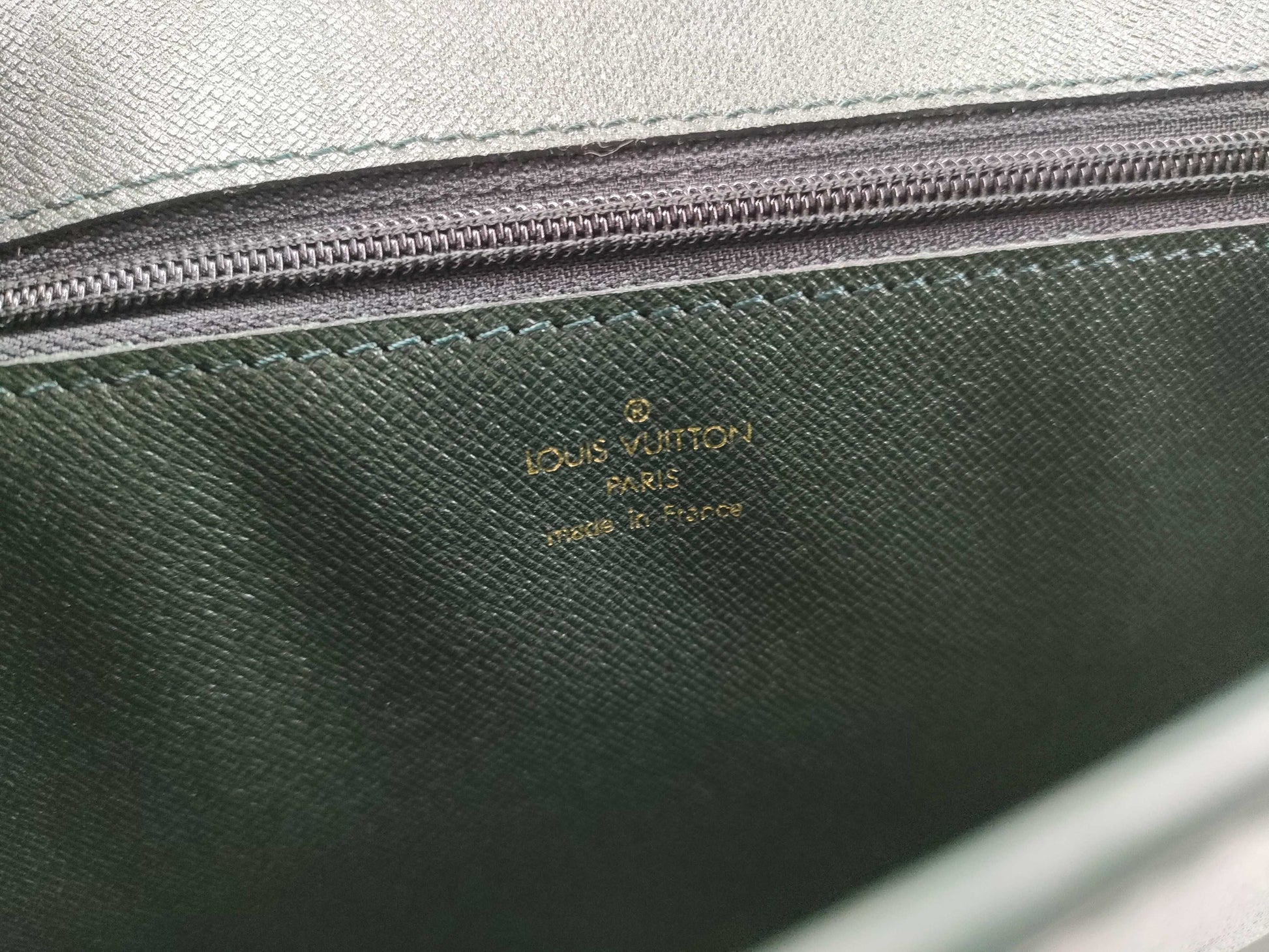 LOUIS VUITTON Taiga flap-style second bag with some deterioration inside the pocket.
