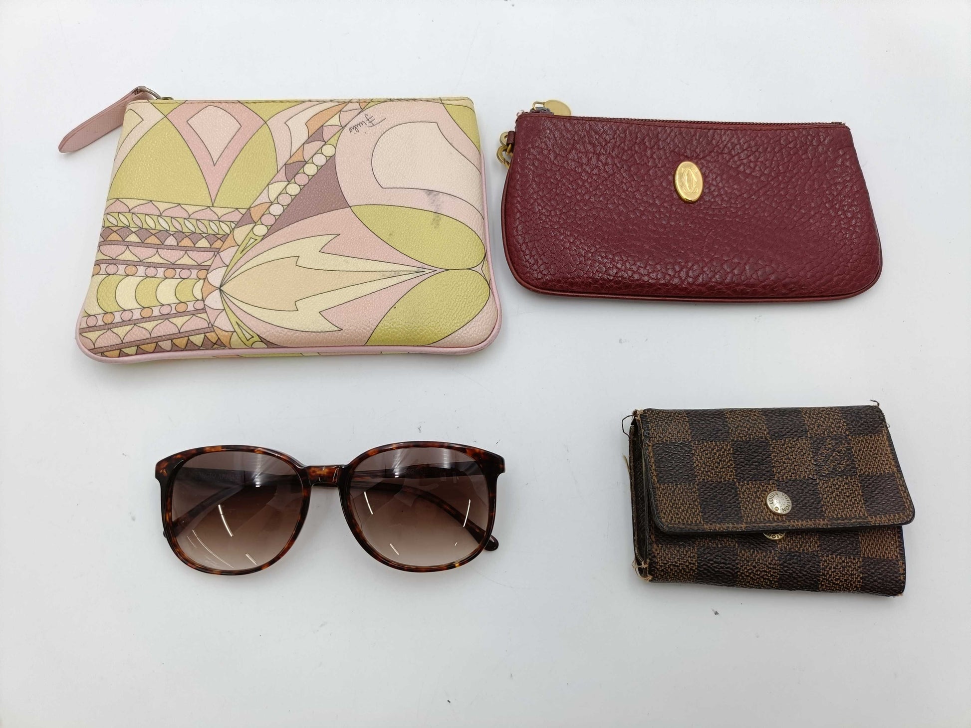 4 items including Armani, Louis Vuitton, Cartier, and Pucci sunglasses.