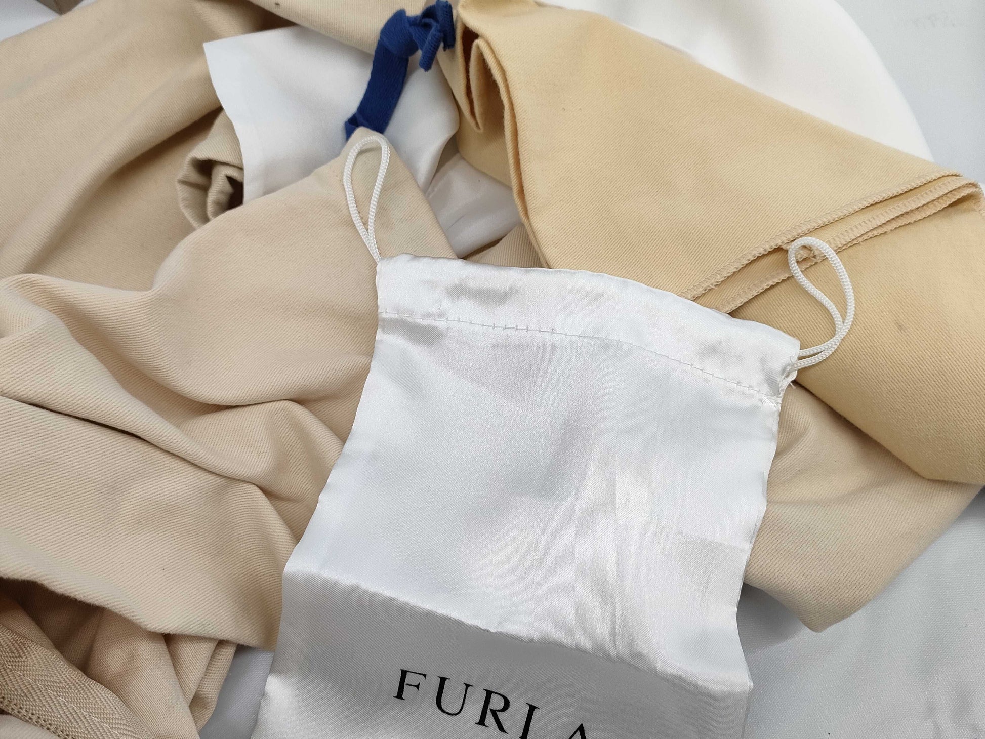 Empty Louis Vuitton, Gucci, Chanel, Loewe, and other brand-name boxes and dust bags. One M-tiered box. Empty brand-name boxes.